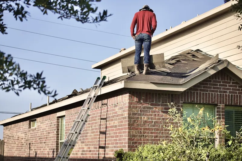 Professional roofer working on a residential roof in Winding River Village